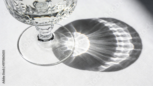 Abstract caustic light ripples on white linen with deep focus