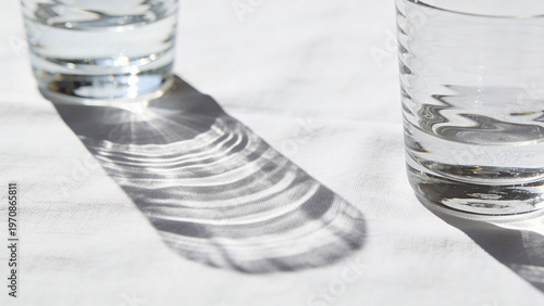 Abstract caustic light ripples on white linen with deep focus