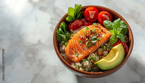 Healthy salmon and quinoa bowl with fresh vegetables and avocado