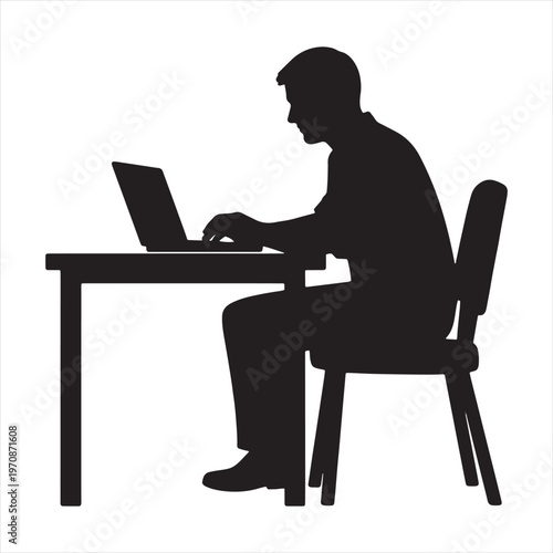 Silhouette of a man sitting at a desk working on a laptop computer