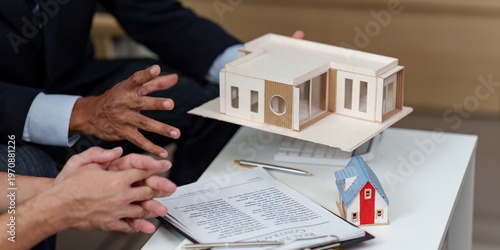 Real estate agent presenting property model to client