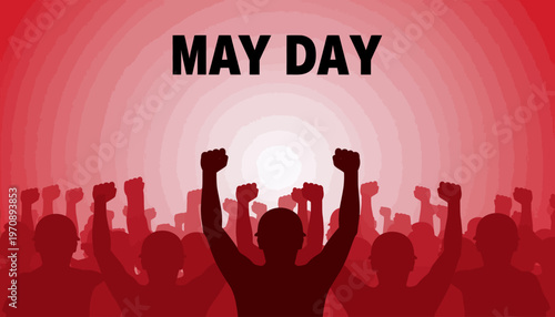 A crowd of people celebrate May Day with raised fists in a city.