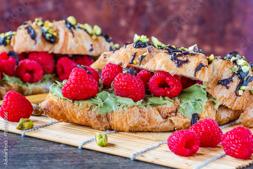Croissants with pistachio cream, fresh raspberries and crushed pistachio nuts