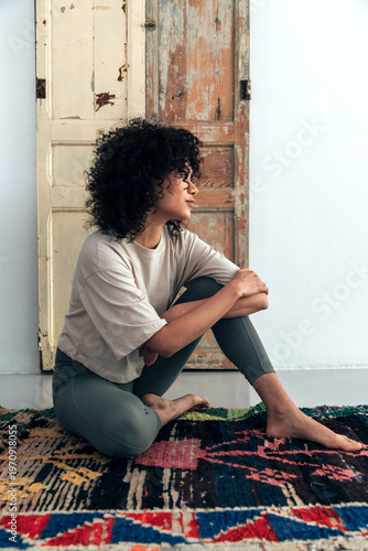 Woman sitting on rug finding calm and peace