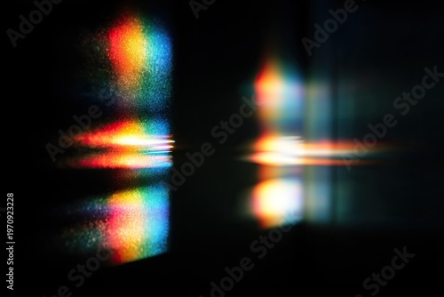 Colorful spectrum of light refracted, reflected, and displayed in a dark environment