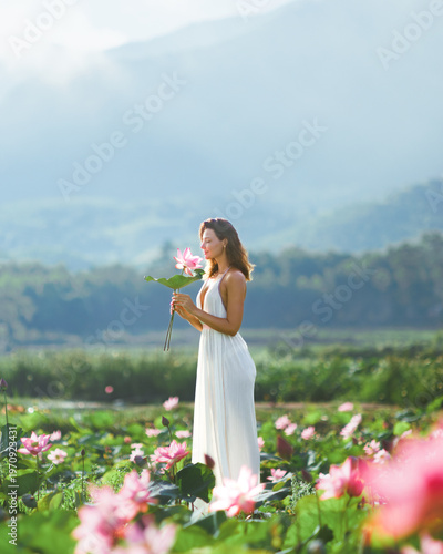 Woman Holding Pink Lotus Flower in Tra Ly Pond Vietnam
