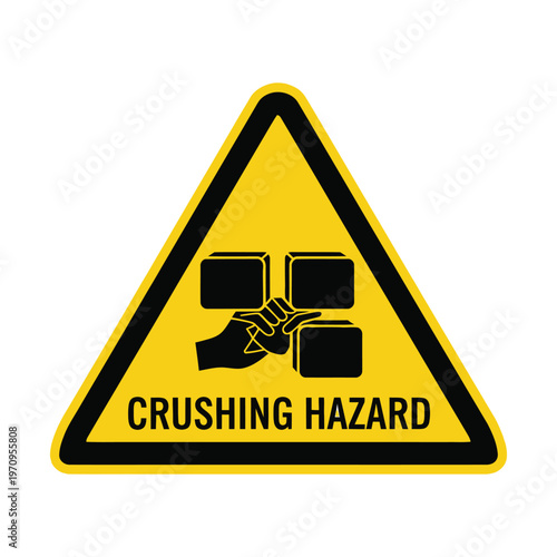 Yellow triangular warning sign indicating a crushing hazard with a hand being squeezed between black blocks, isolated on white background.
