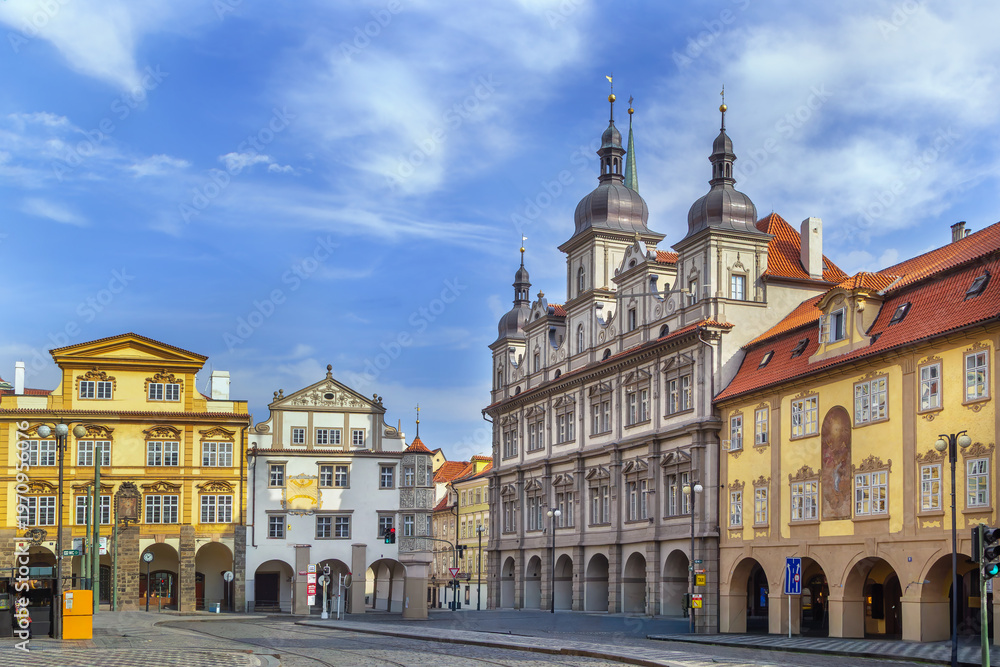 Obraz premium Malostranske Square in Prague city centre, Czech Republic. Historical baroque architecture under partly cloudy blue sky