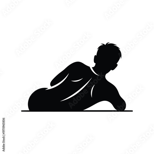 Silhouette of a man lying on his stomach, looking back over his shoulder.