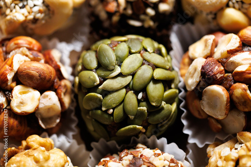 Handcrafted no-bake bites with visible hazelnuts, pumpkin seeds, and oats