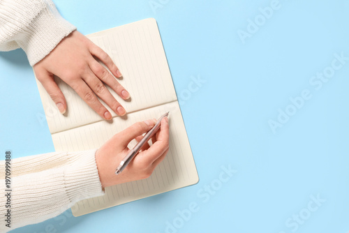 Female hands with notebook ...