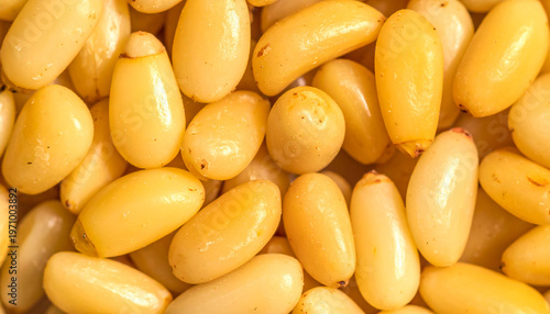 Close up of shelled pine nuts with a light yellow hue and smooth texture food ingredient