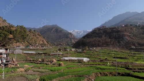 Scenic Mountain Valley Village with Green Terraced Fields and Snow-Capped Peaks, 4K