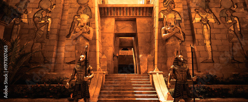 Fotografi Egypt Wide view of a grand sandstone temple entrance featuring guardian pharaoh statues and ritual braziers