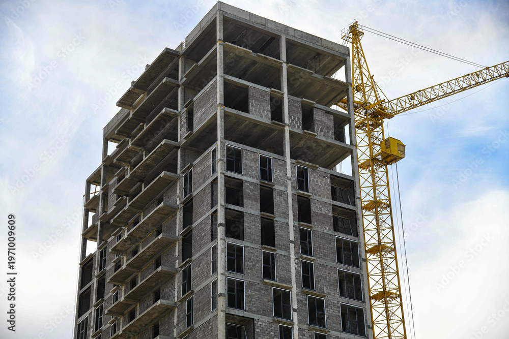 Fototapeta premium The construction site of a multi-storey building in an urban environment.