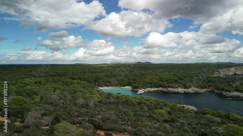 Aerial drone view flight to Cala Turqueta, Menorca Island, Balearic islands, Spain. Clean turquoise water and surrounded by wildlife