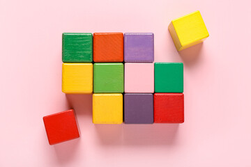 Colorful building cubes on pink background