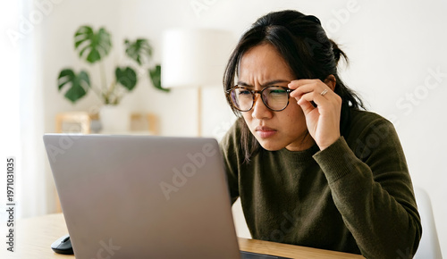 Woman leans closer to screen to see details more clearly.