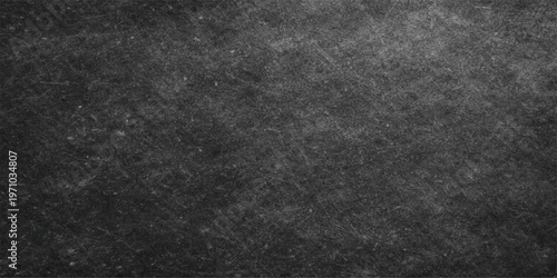 Abstract close-up view of a dark and textured chalkboard, etched with subtle markings and scratches, conveying a sense of age and use.
