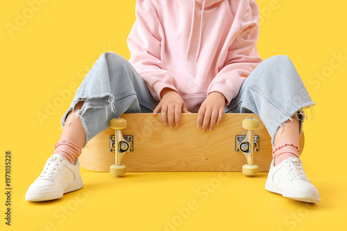 Young woman with skateboard...