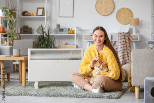 Young woman with cute cat w...