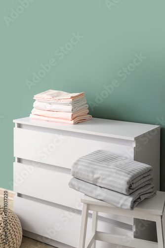 Folded bed sheets on commod...