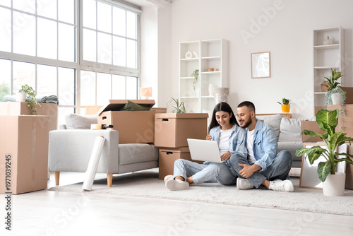Young couple using laptop i...