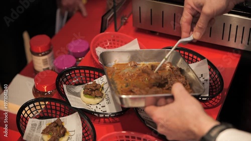 Close-up of a chef’s hands preparing meat bao buns