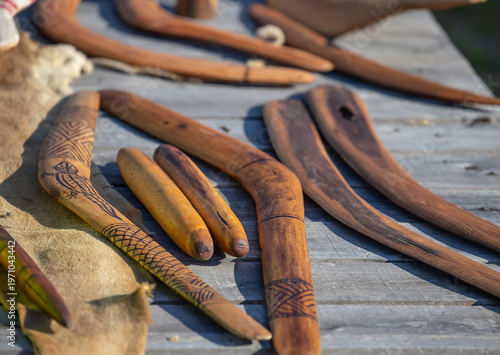 Aboriginal boomerangs and clap sticks on wooden surface traditional indigenous craft works Australia