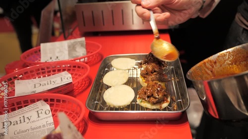Close-up of a chef’s hands preparing meat bao buns