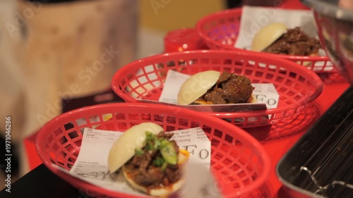 Close-up of a chef’s hands preparing meat bao buns