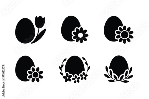 A set of black Easter eggs with floral designs on white