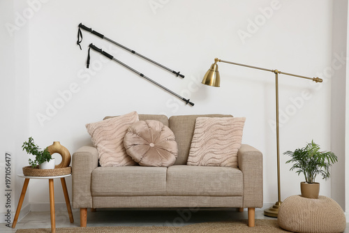 Interior of living room with Nordic walking poles and sofa