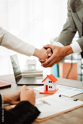 Obraz na plátne Real estate agents present model homes to clients, arrange mortgage loan agreements, and handle home purchase agreements