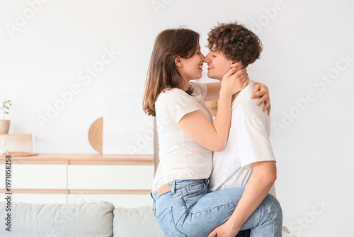 Young couple kissing at home