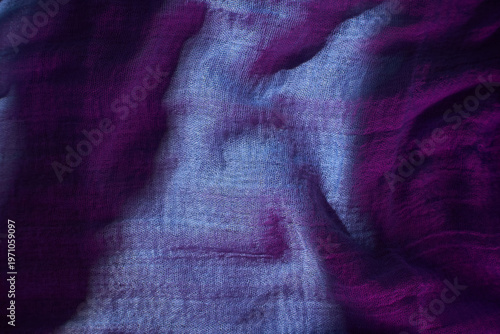 Colorful fabric with shadow patterns reflecting light in a studio setting during the day