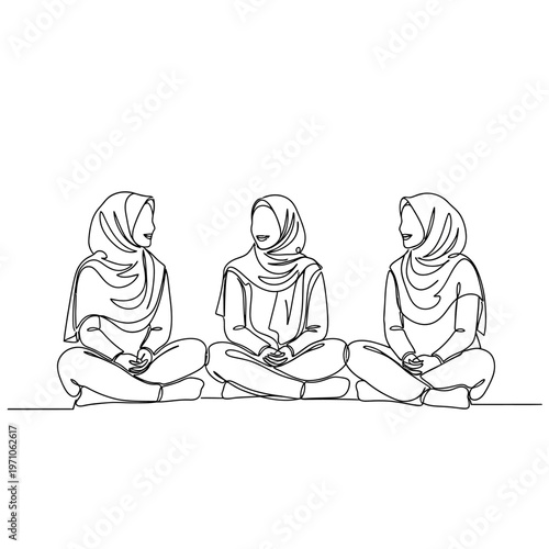 Three women wearing headscarves sitting.