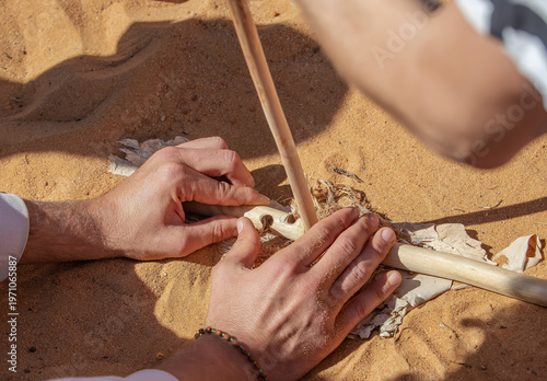 Traditional fire making by friction using wooden sticks in Australian indigenous survival practice