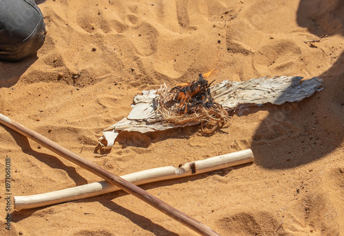 Traditional fire making by friction using wooden sticks in Australian indigenous survival practice