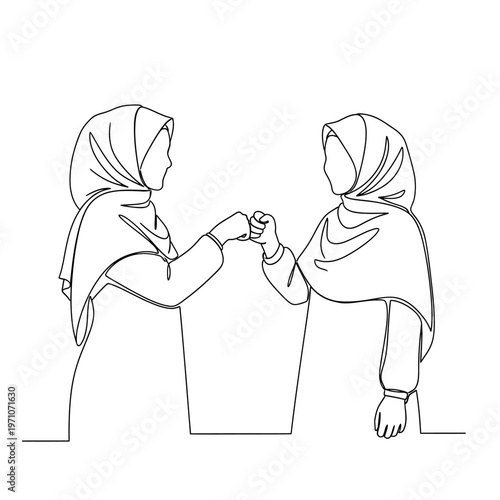 Two women wearing headscarves together.