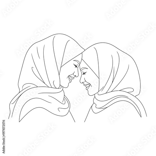 Two women wearing headscarves smiling.