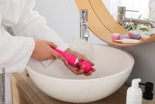 Woman washing vibrator over...