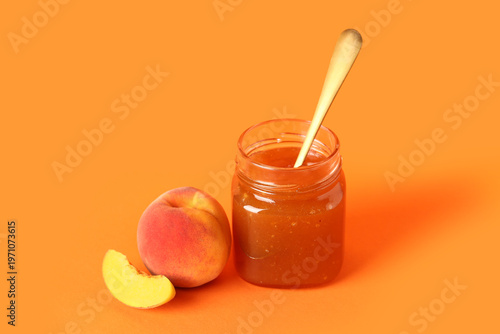Jar with sweet peach jam an...