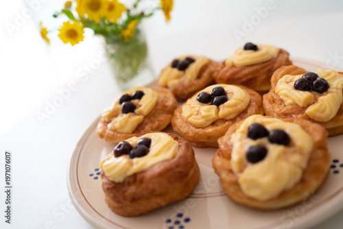 Zeppole di San Giuseppe. A traditional Italian pastry filled with custard and topped with black cherries, typically served on Father's Day. Traditional pastry.
