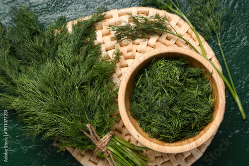 Foto Bowl with fresh dill on green background