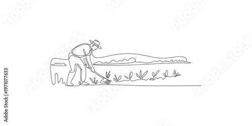 Man working on farm with hoe in field and mountains in background farmer agriculture farming