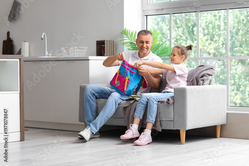 Father helping his little d...