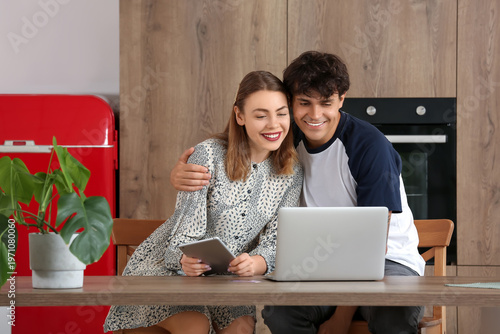 Young couple with laptop an...