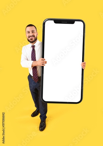 Happy businessman holding b...