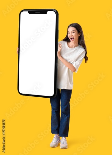 Happy young woman holding b...